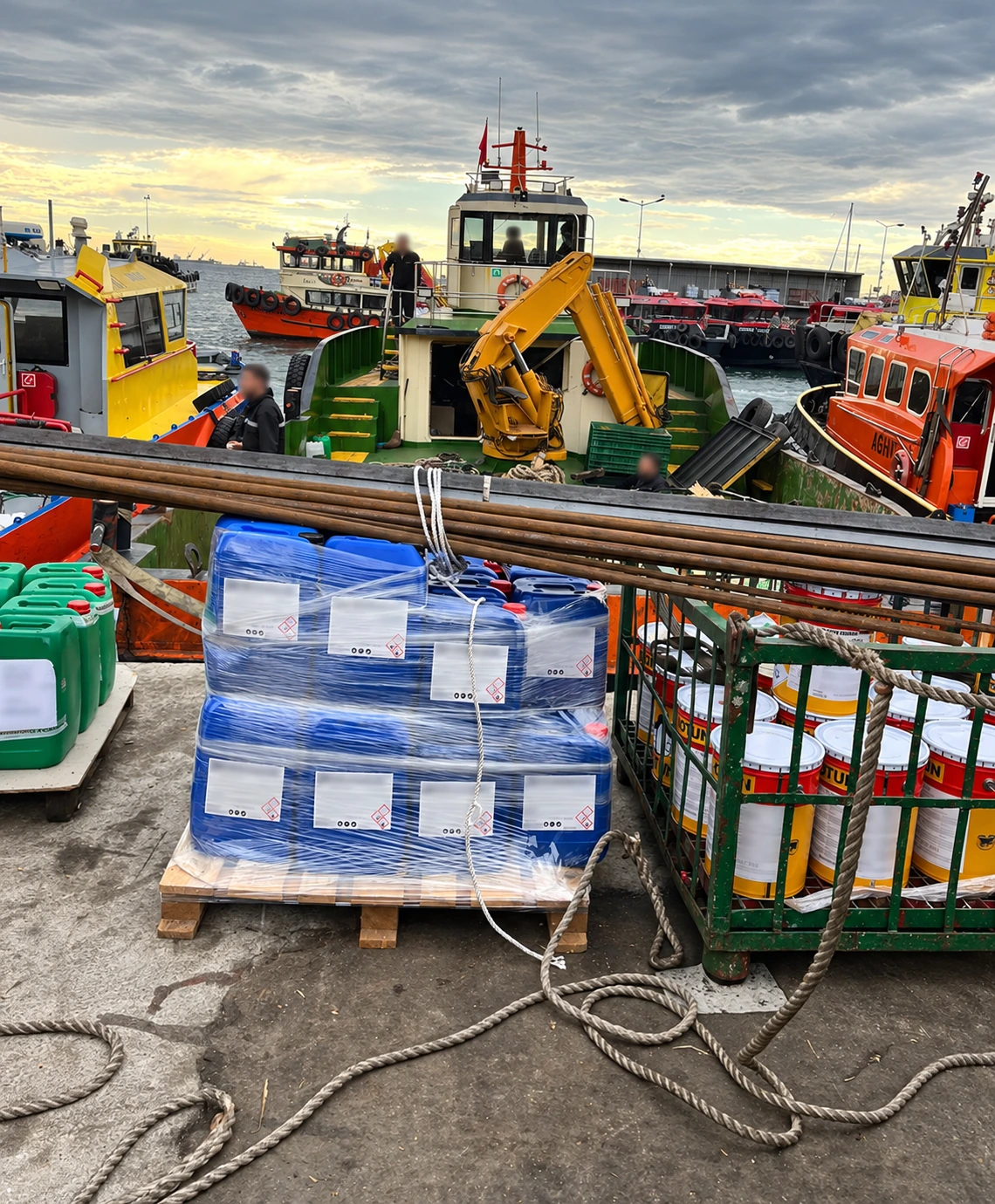 Marine chemical containers and paint supplies at the port; photo edited for privacy